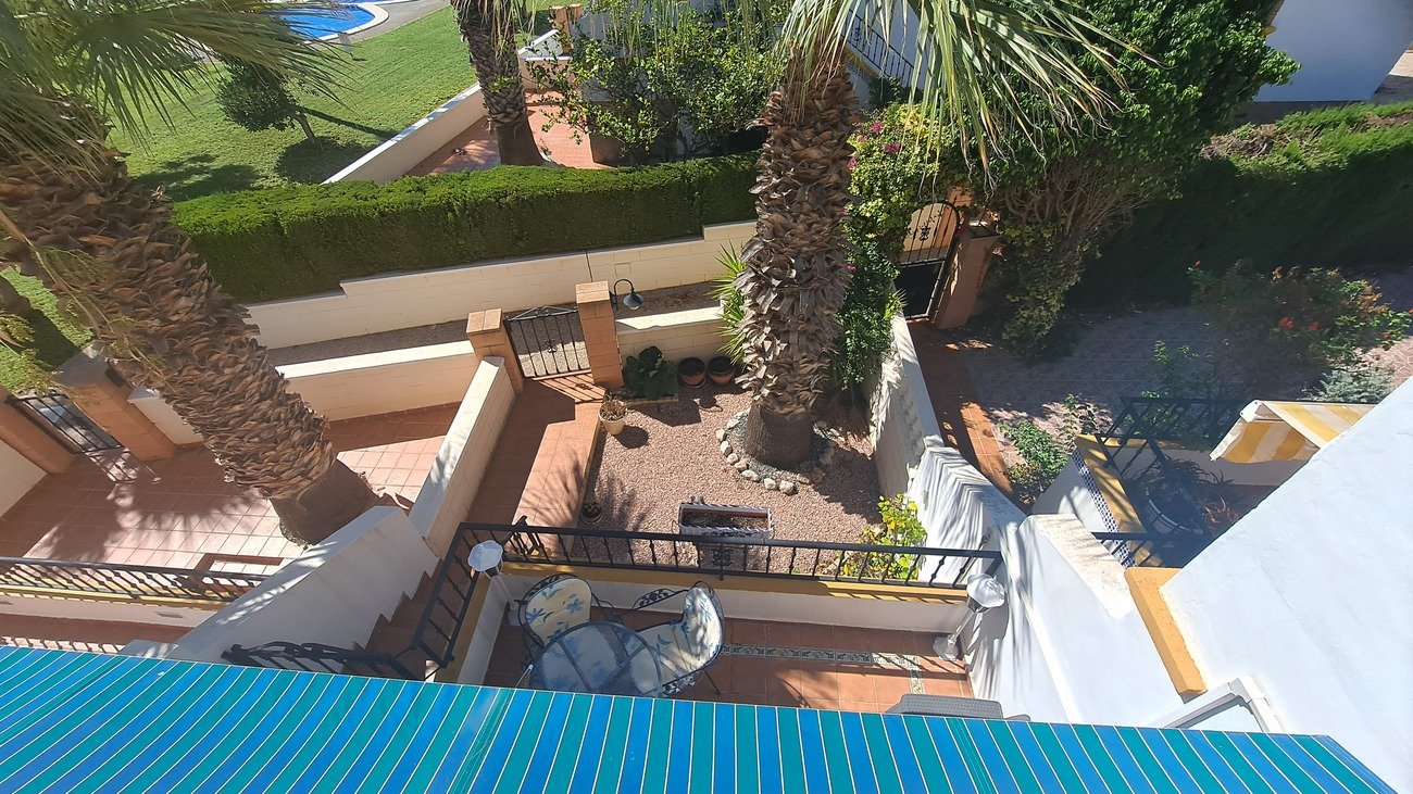 This well-proportioned townhouse offers excellent outdoor space, a practical layout, and a superb location. With a communal swimming pool and easy a