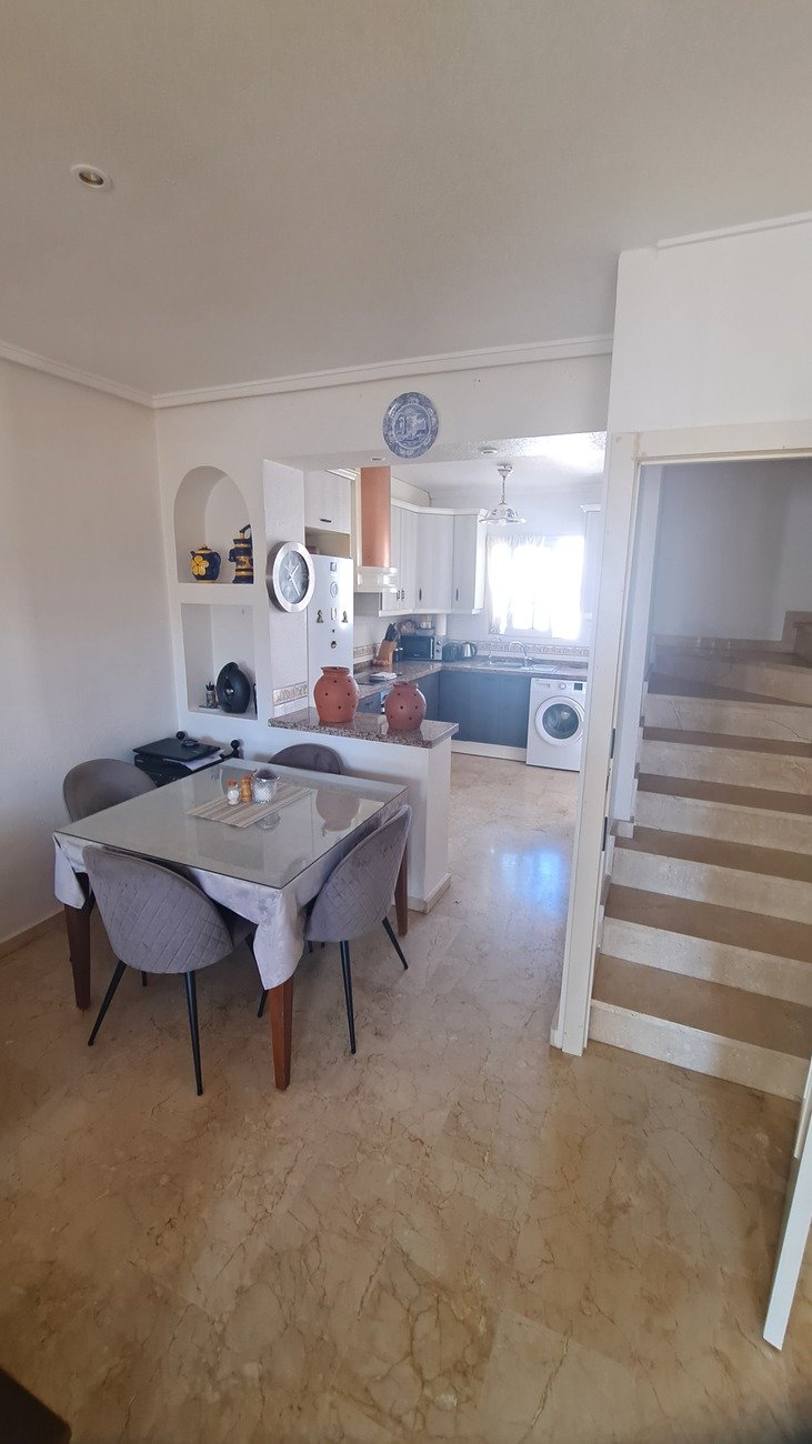 This well-proportioned townhouse offers excellent outdoor space, a practical layout, and a superb location. With a communal swimming pool and easy a