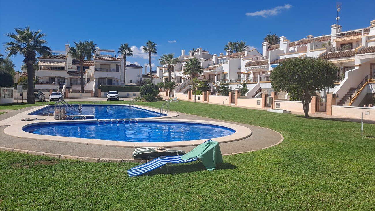 This well-proportioned townhouse offers excellent outdoor space, a practical layout, and a superb location. With a communal swimming pool and easy a