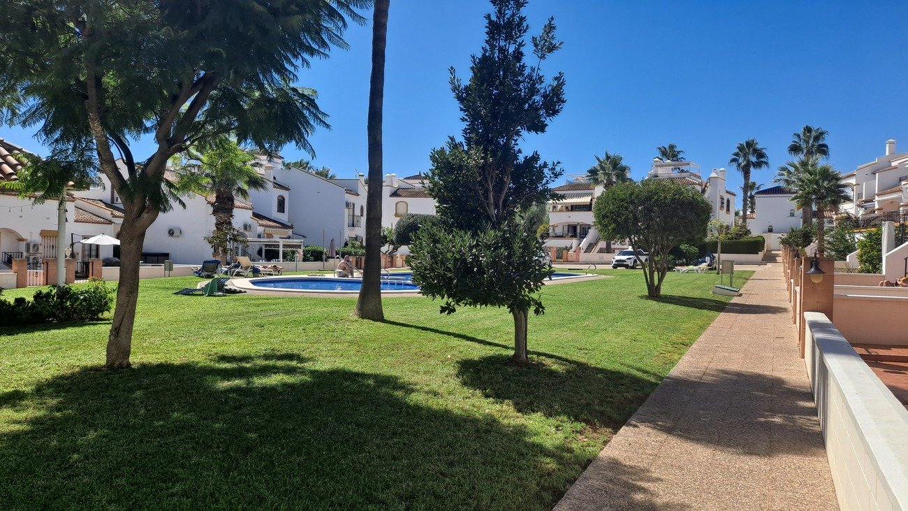 This well-proportioned townhouse offers excellent outdoor space, a practical layout, and a superb location. With a communal swimming pool and easy a