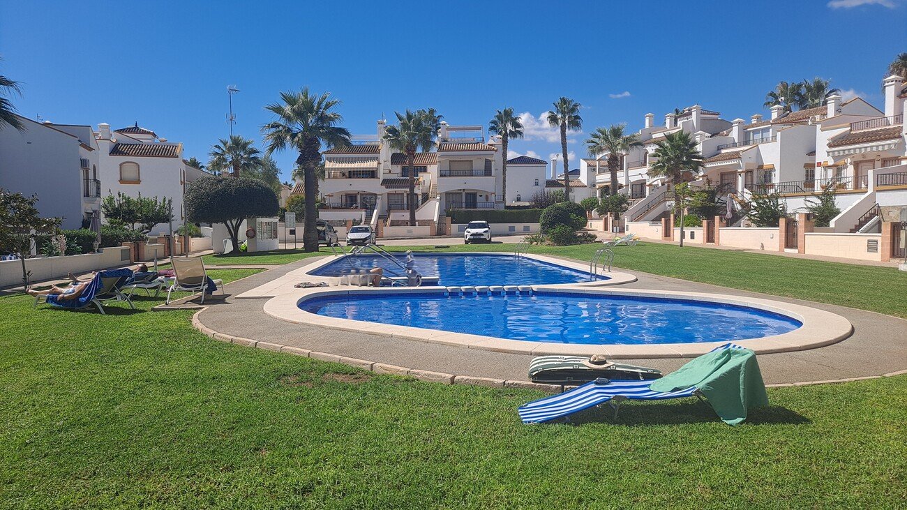 This well-proportioned townhouse offers excellent outdoor space, a practical layout, and a superb location. With a communal swimming pool and easy a