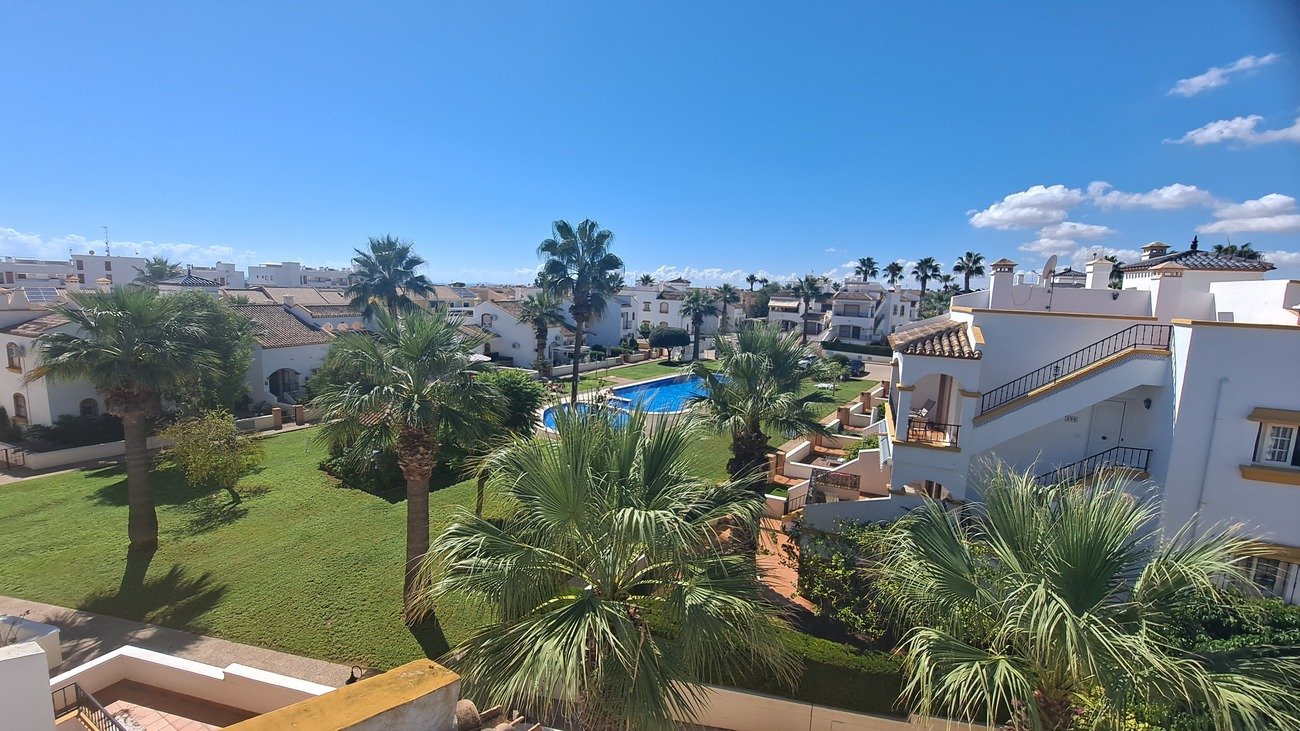 This well-proportioned townhouse offers excellent outdoor space, a practical layout, and a superb location. With a communal swimming pool and easy a