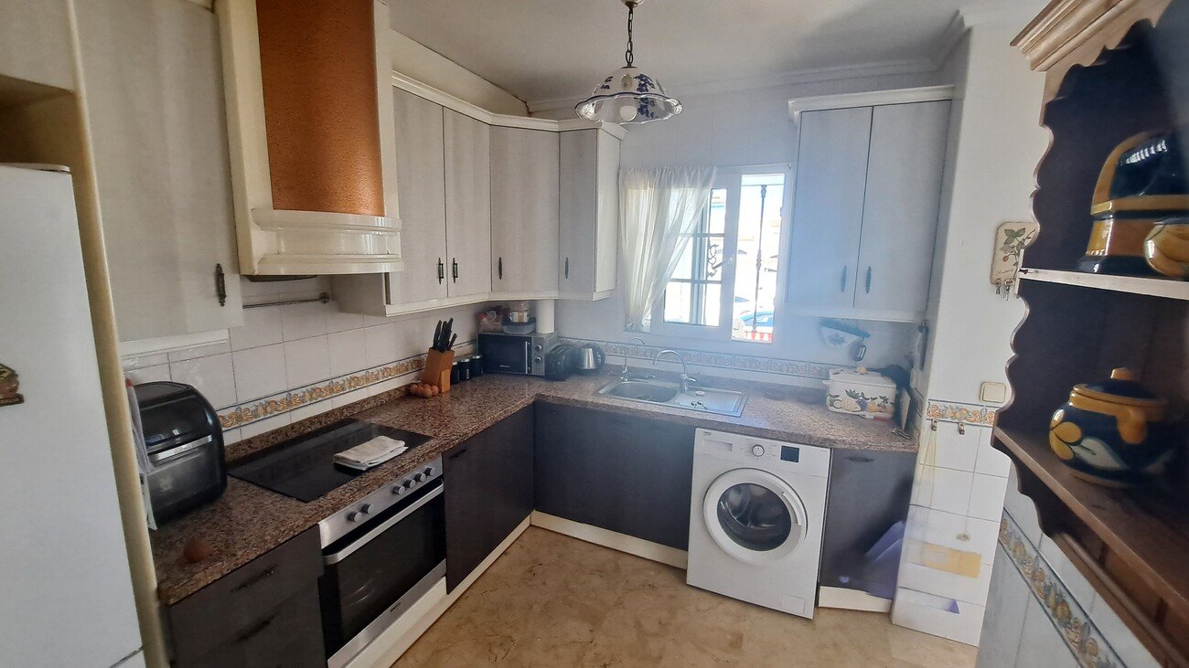 This well-proportioned townhouse offers excellent outdoor space, a practical layout, and a superb location. With a communal swimming pool and easy a