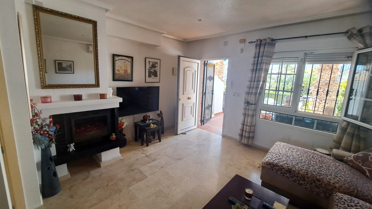 This well-proportioned townhouse offers excellent outdoor space, a practical layout, and a superb location. With a communal swimming pool and easy a