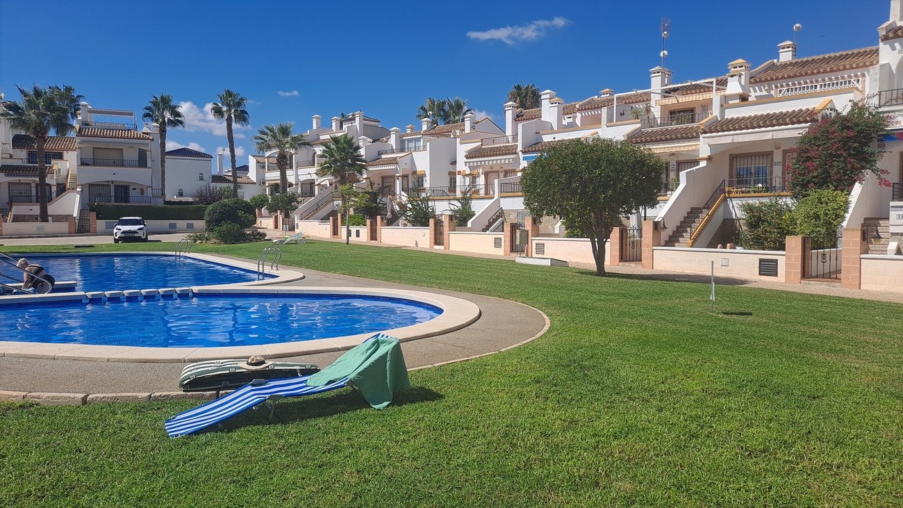 This well-proportioned townhouse offers excellent outdoor space, a practical layout, and a superb location. With a communal swimming pool and easy a